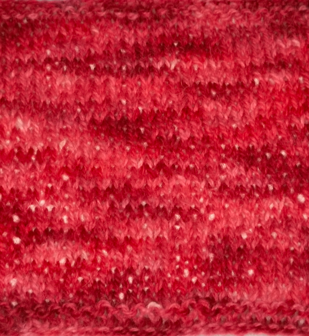 Swatch of yarn with tones of red